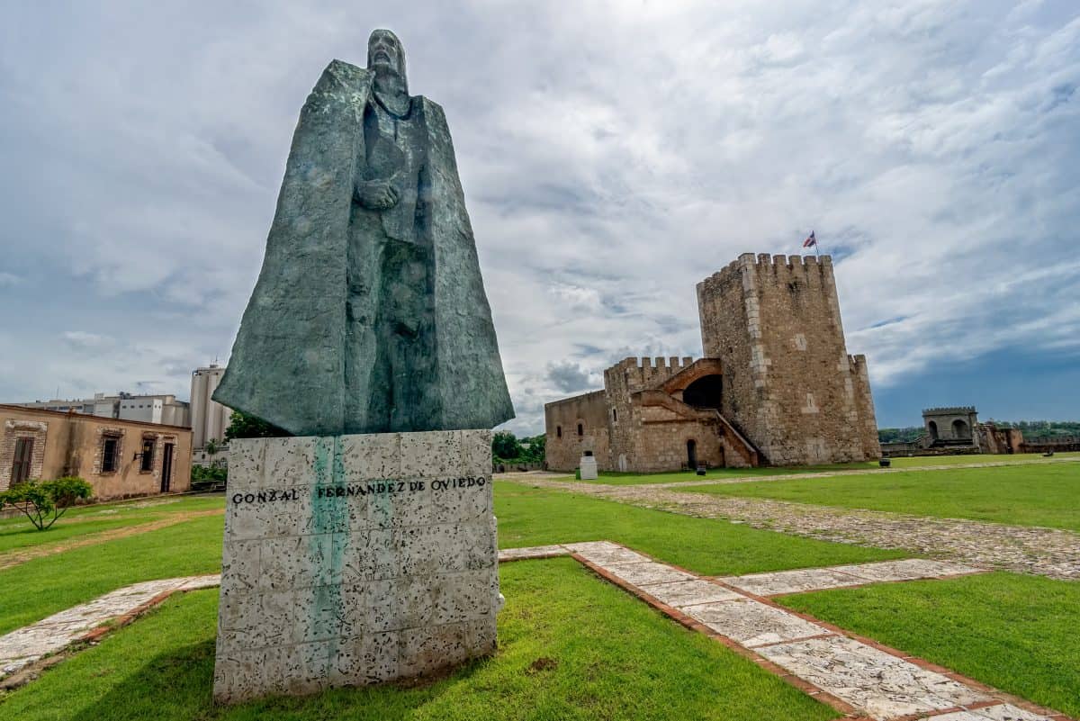 Statue of Gonzalo Fernandez de Oviedo in front of fortress in old part of Santo Domi.