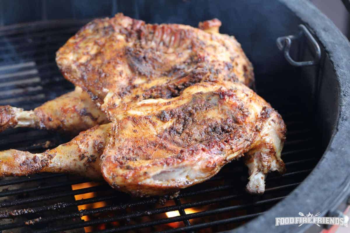 A spatchcok chicken on a Kamado Joe grill