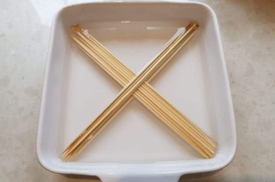 Some bamboo skewers soaking in a b.