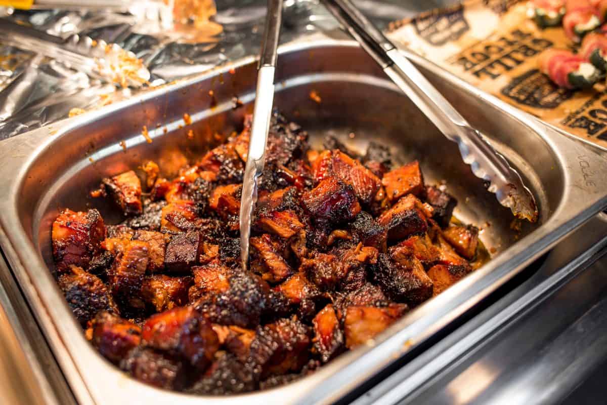 A food tray of sauced brisket burnt ends