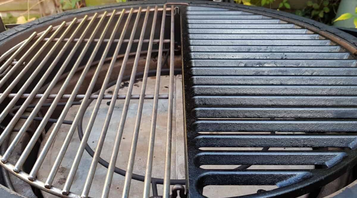 Close up of a half cast iron and half stainless steel grate installed into a Kamado Joe.