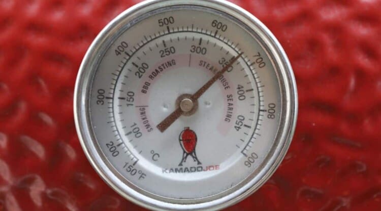 A temperature gauge showing 350 degrees c on a red Kamado Joe grill.
