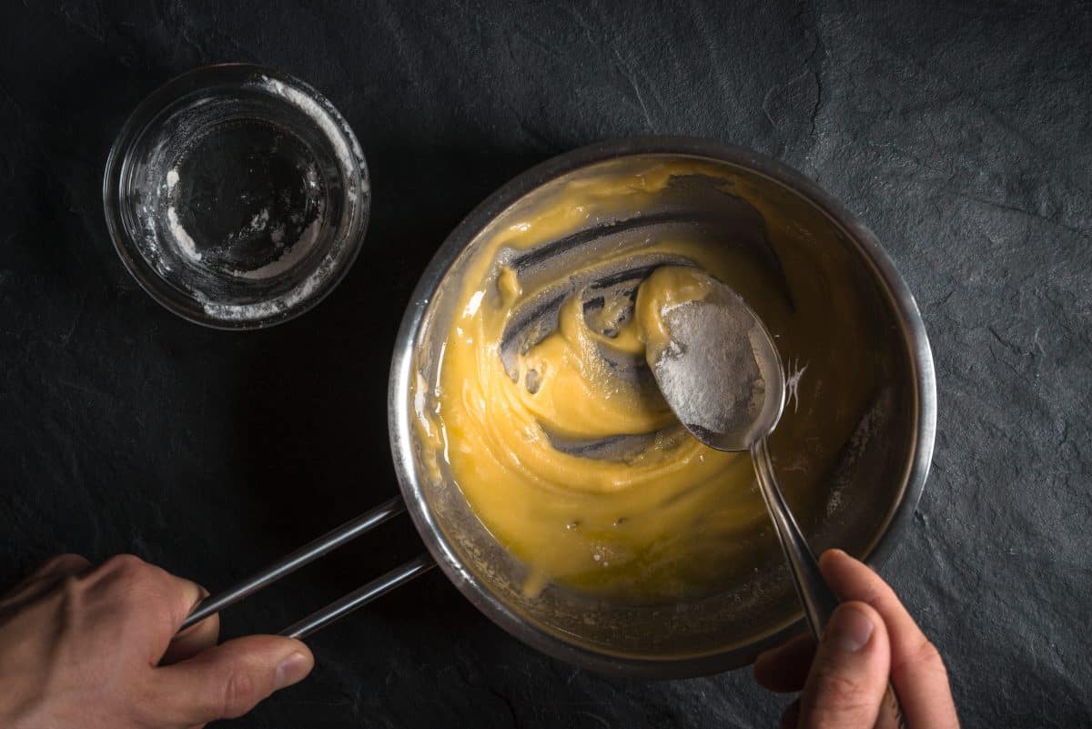 Making a roux with butter and flour: A pan and empty glass shot from ab.