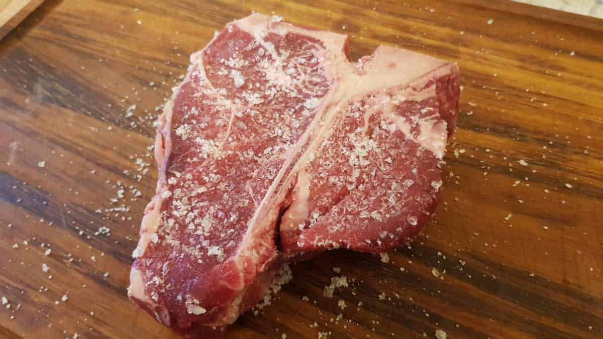 A porterhouse steak dry brined with sea s.