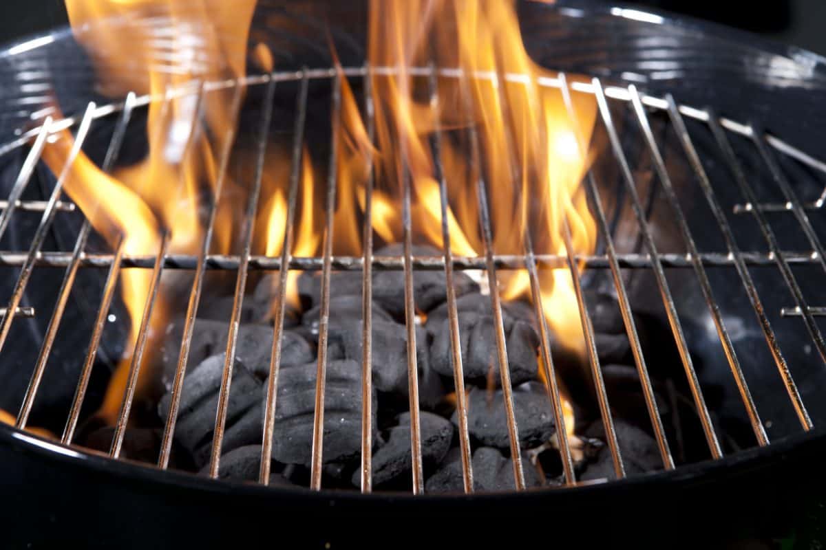 Burning briquettes in a brand-new charcoal gr.