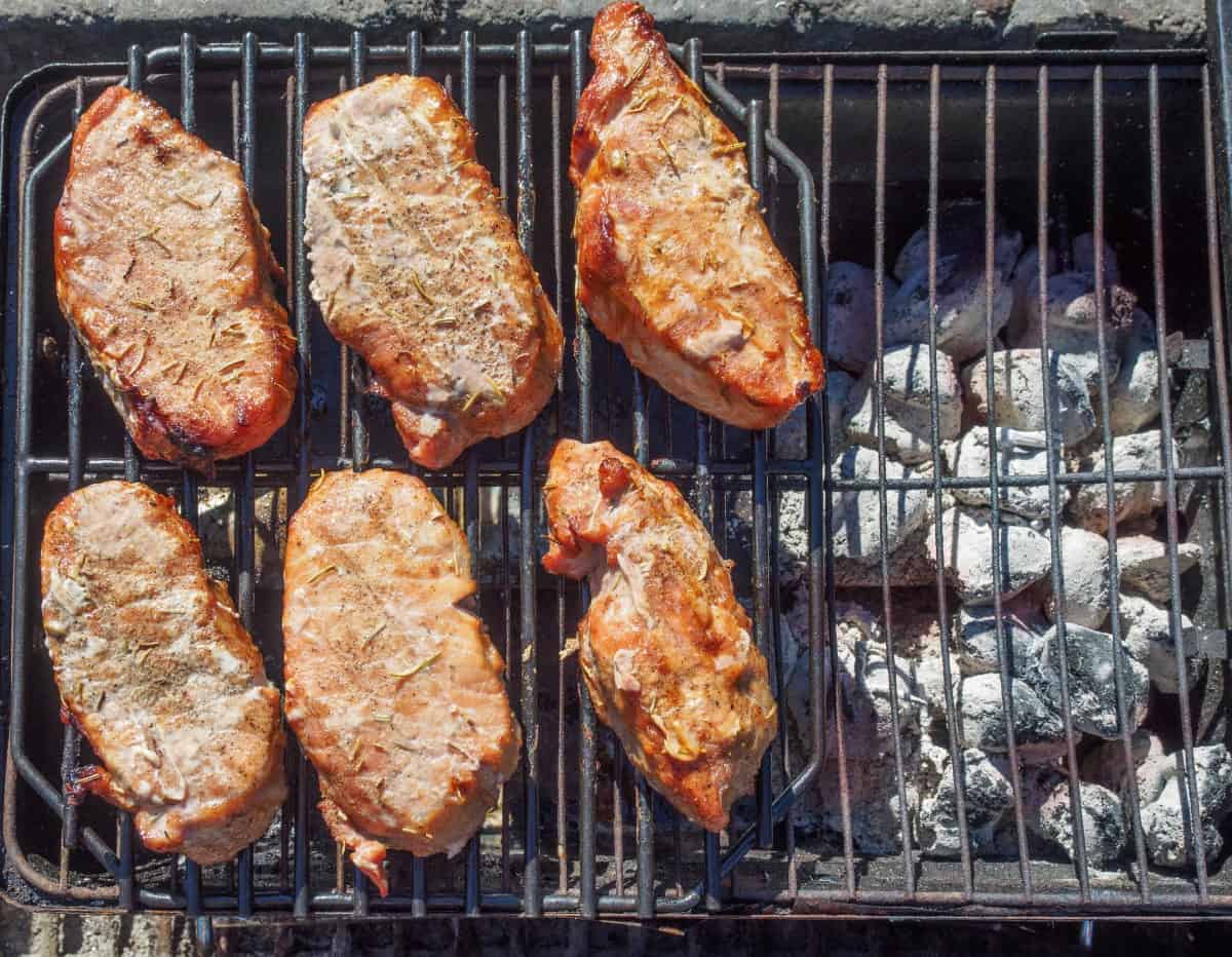 pork chops grilling indirect on a small charcoal gr.