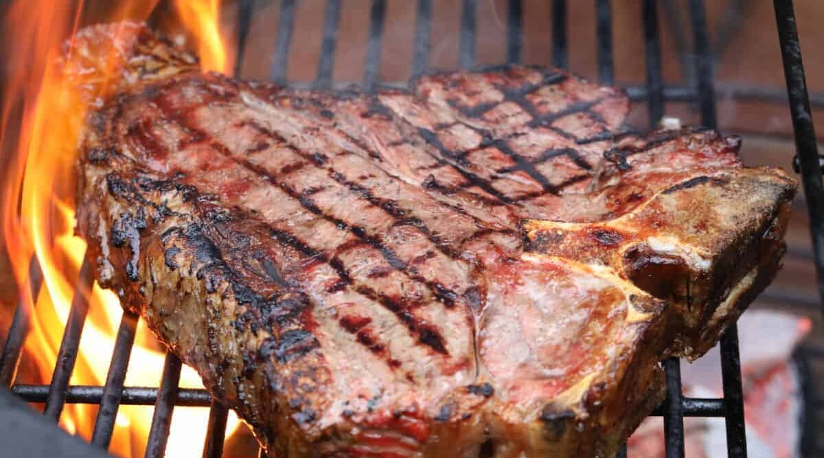 A porterhouse steak on the grill.