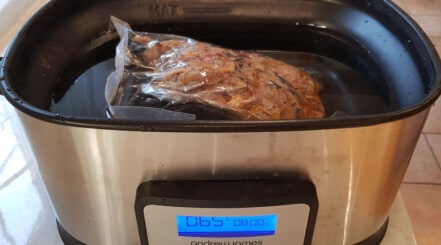 Close up of reheating pulled pork in a sous vide bath.