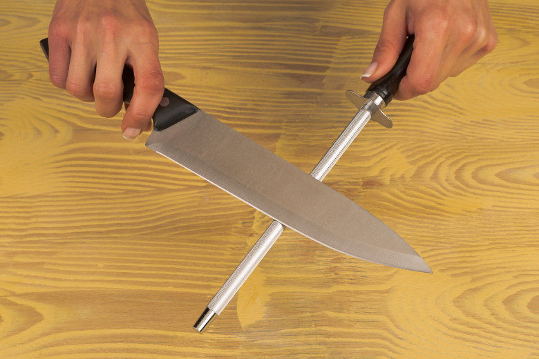 Image of a knife sharpening steel being used to hone a kitchen knife