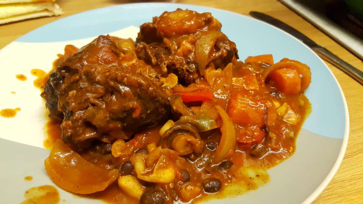 Smoked ox tail stew on a dinner plate.