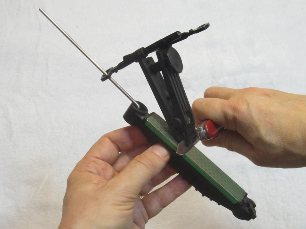 A Swiss army knife being sharpened on a knife sharpening sys.