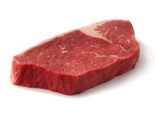 A raw bottom round steak isolated on wh.