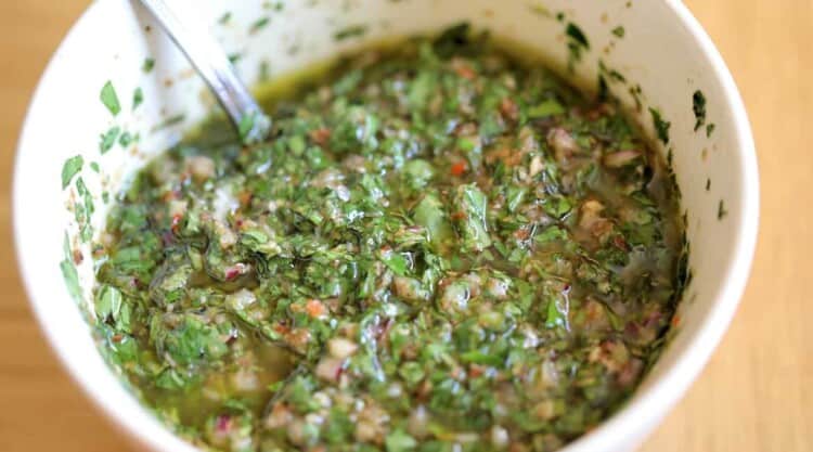 Close up of a bowl of chimichurri sauce