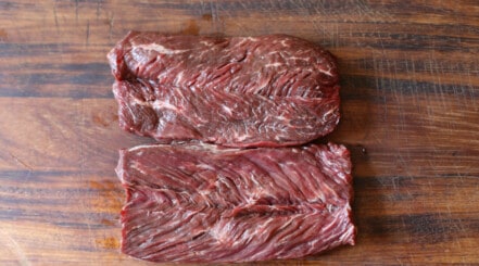 Close up of two bits of hanger steak — tough and benefit from tenderizing
