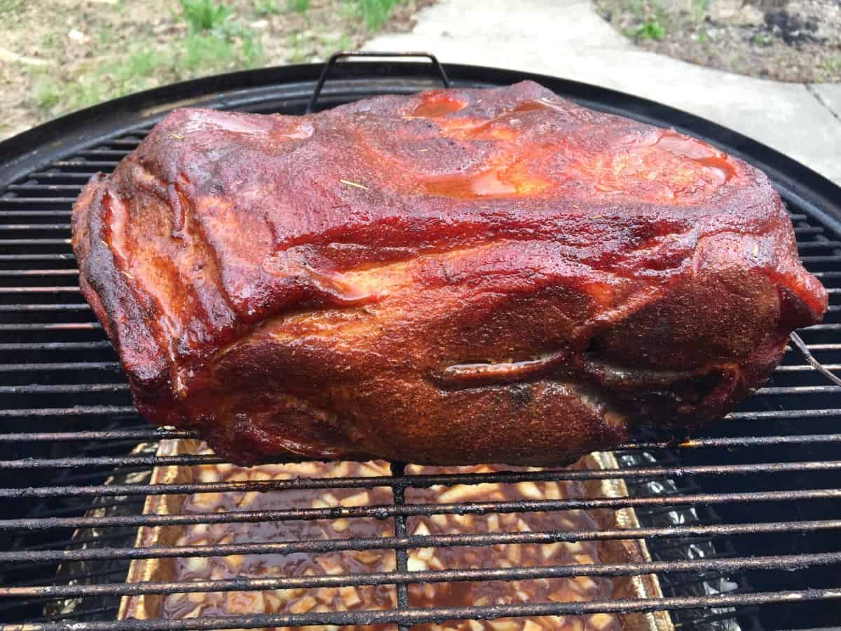 A pork butt fat down on a smoker