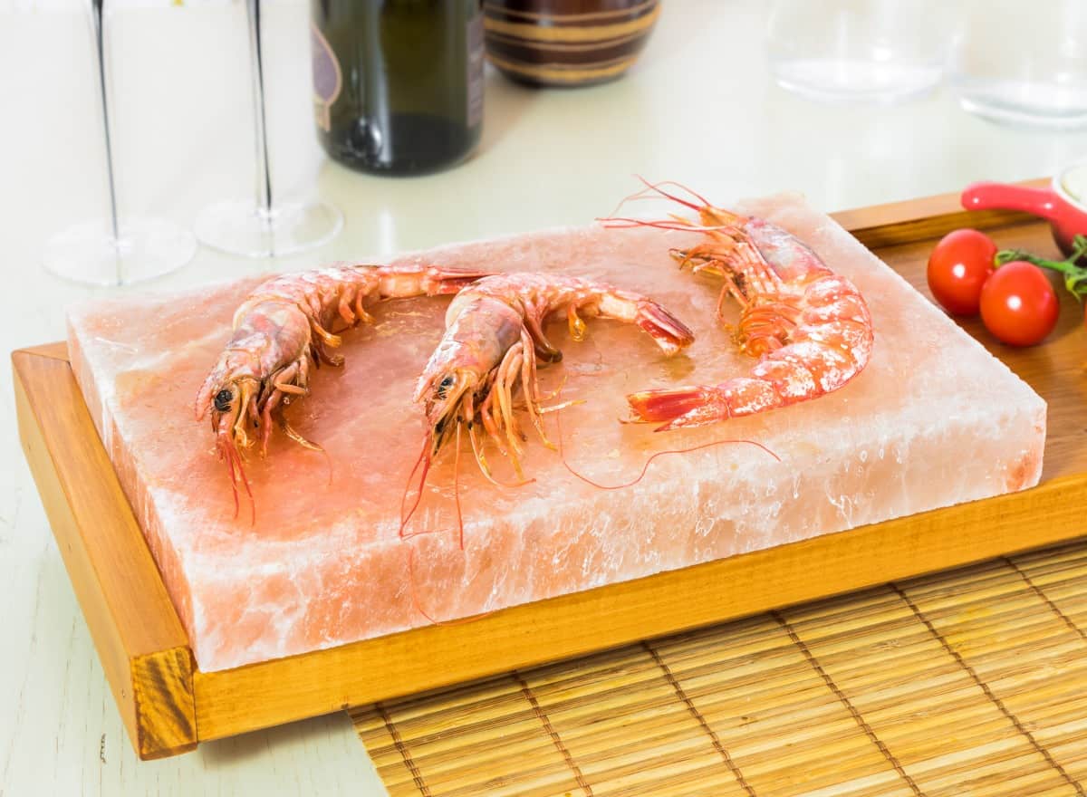 3 giant shrimp being cooked on salt bl.