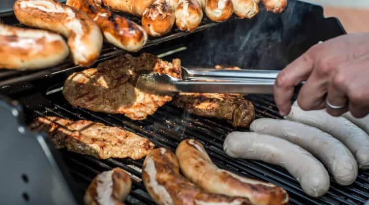 German sausage and chicken grilling on a gas grill.