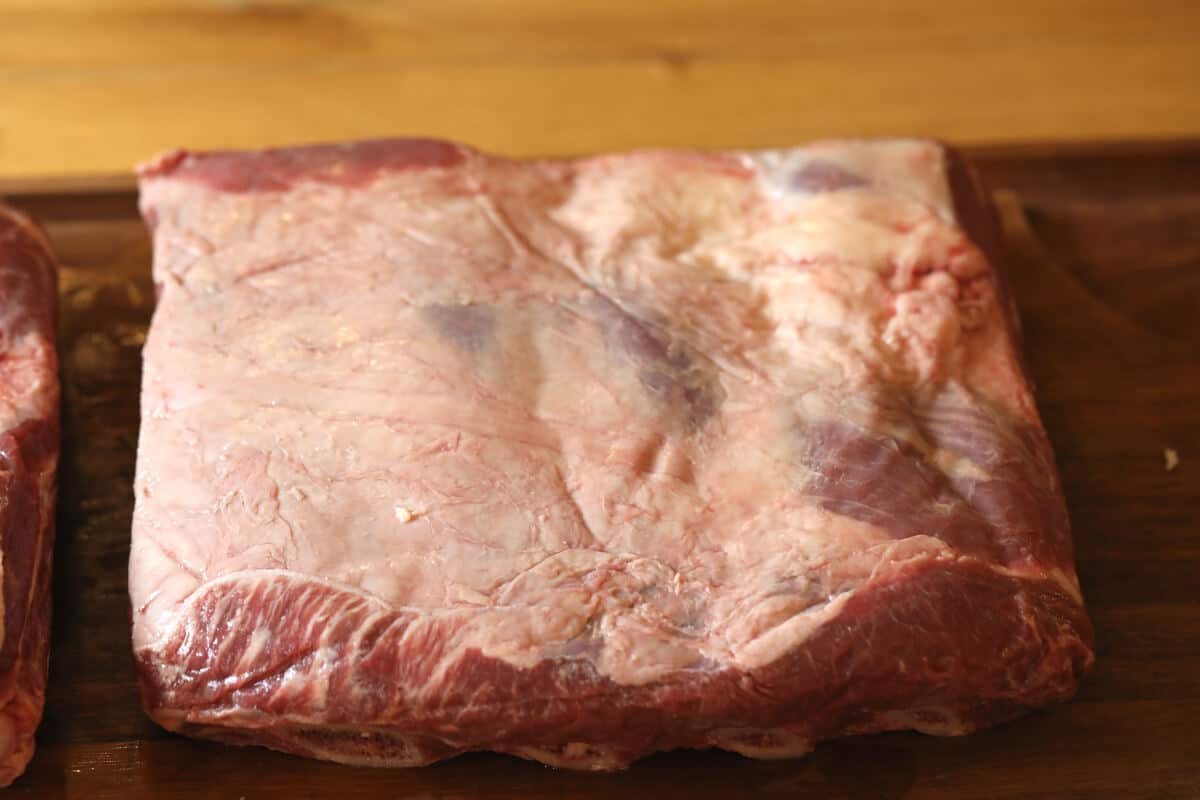 Overhead shot of rack of beef ribs showing the fat .