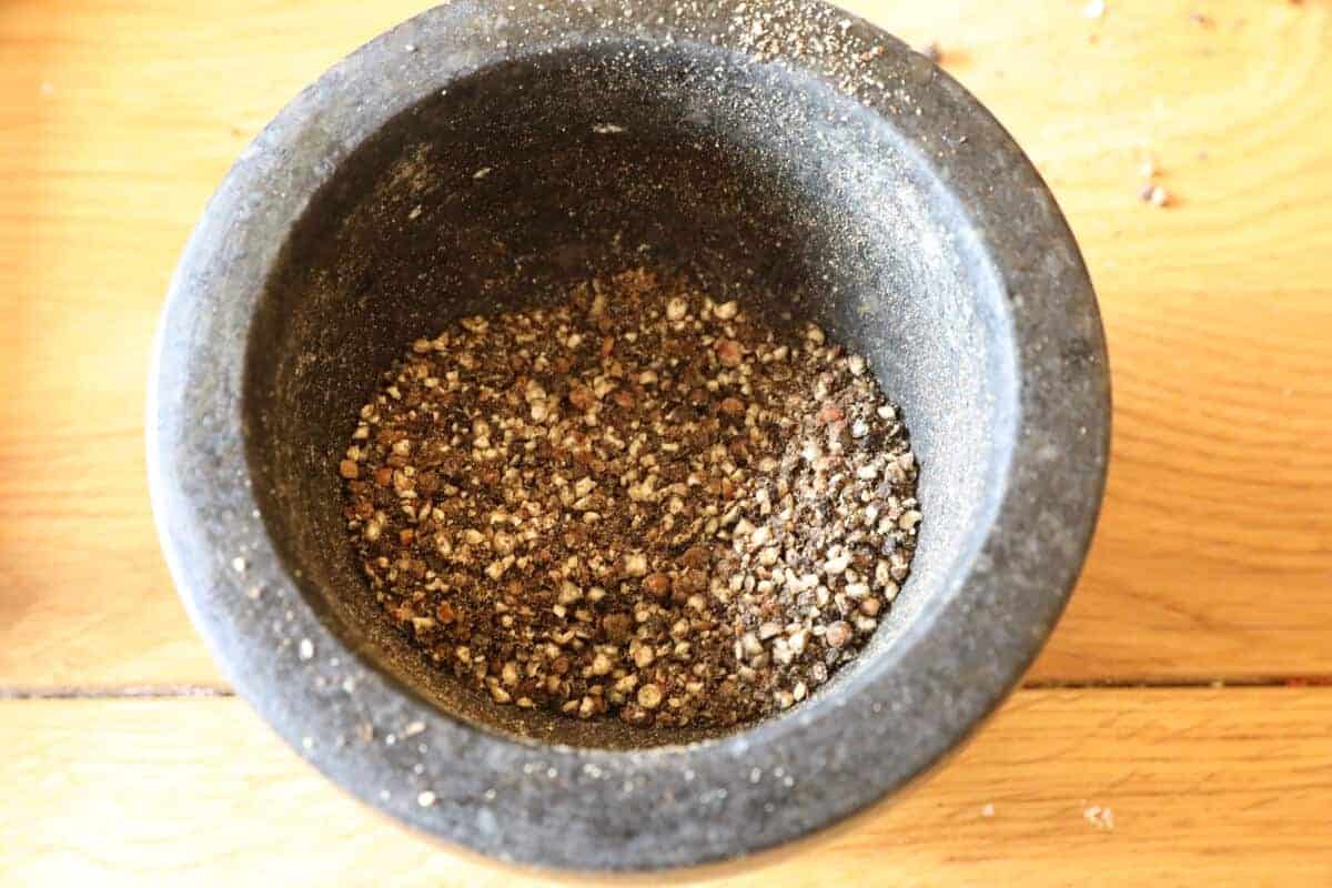 Close up of a dry rub prepared in a pestle and mortar