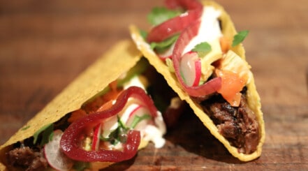 2 beef cheek tacos with onion, cheese, soured cream, coriander