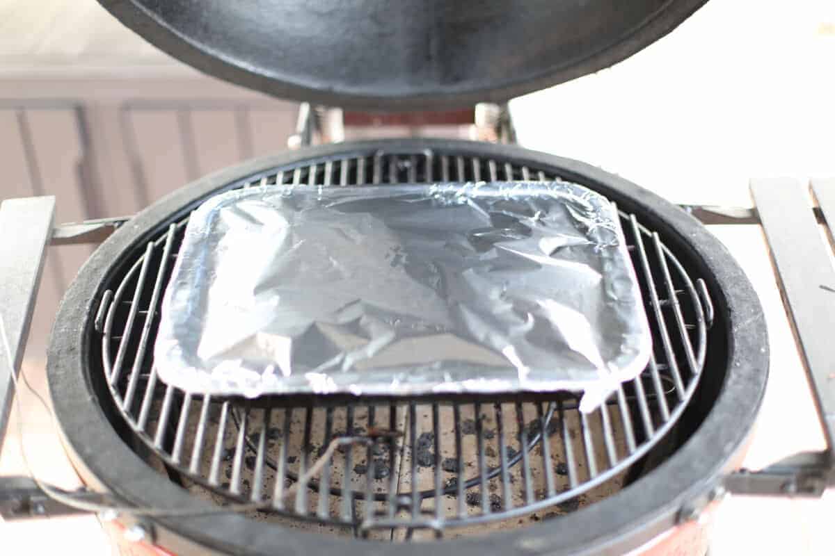 Aluminum sealed tray inside a Kamado Joe smoker