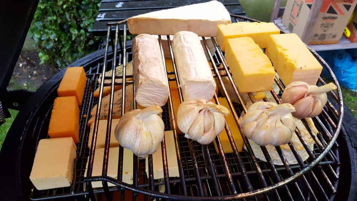 Lots of cheese and garlic being cold smoked in a Kamado .