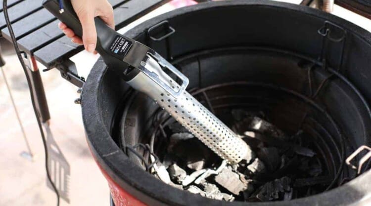 Close up of a Looftlighter being used to light a Kamado Joe grill and smoker