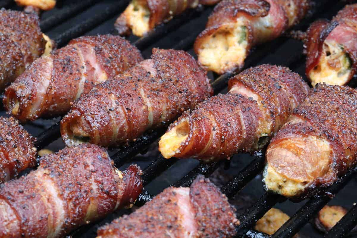 Crispy bacon wrapped smoked jalapeños on a gr.
