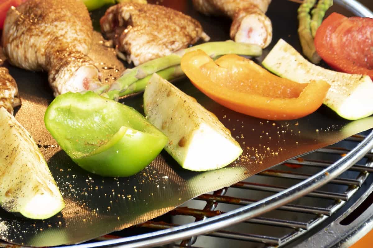 vegetables roasting on a grill mat inside a kamado Joe grill