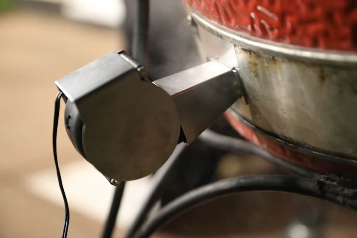 Close up of flame boss 500 blower attached to a Kamado Joe.