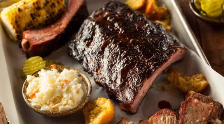 ribs, corn and coleslaw as part of a bbq platter