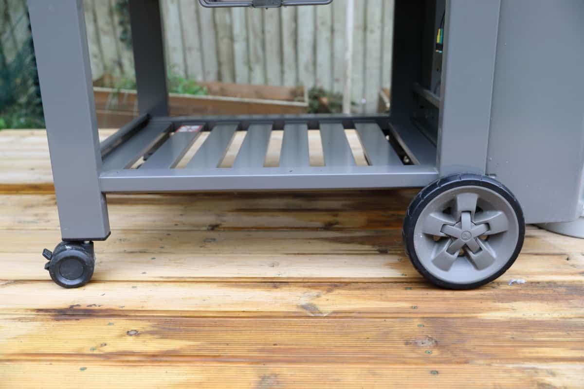 The weber genesis II E-310 storage shelf and wheels.