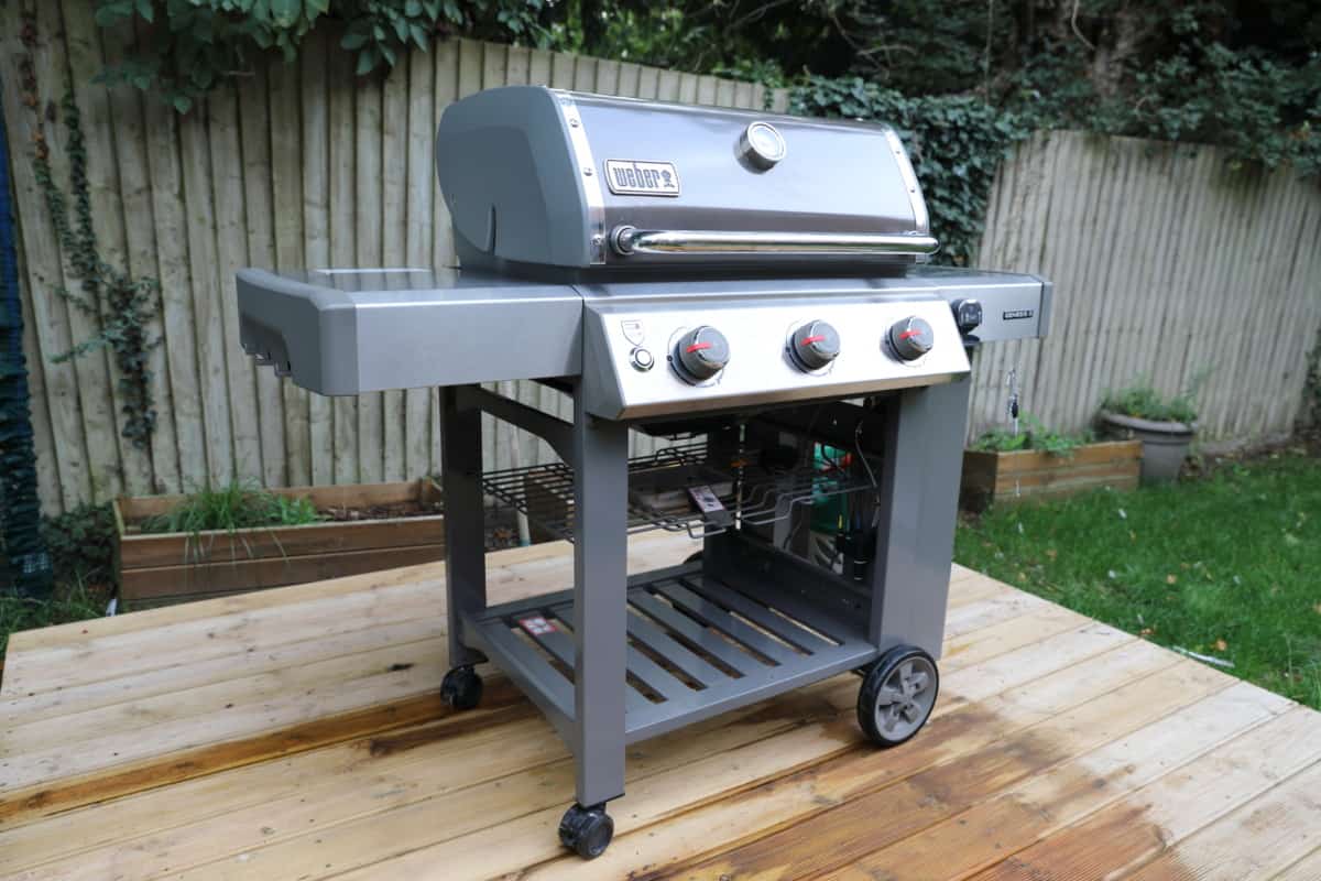 weber genesis II E-310 side angle view on a wooden deck.