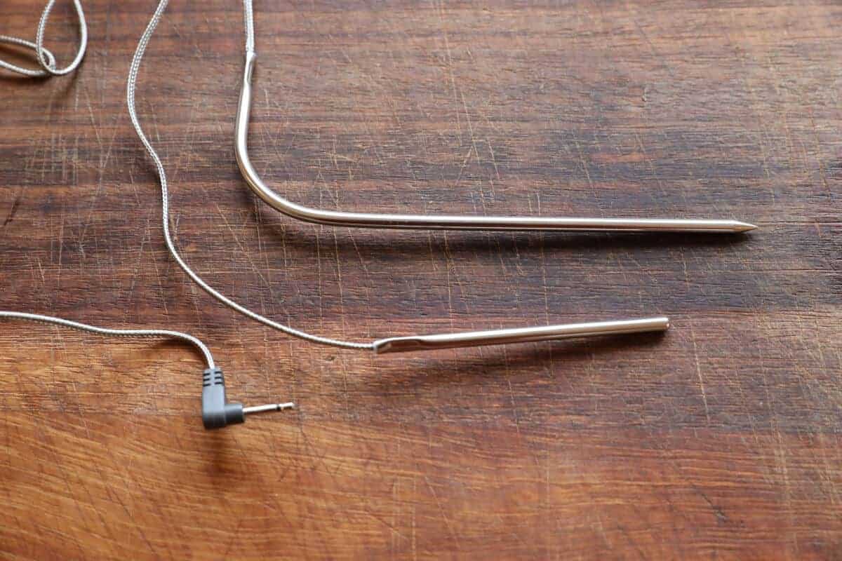 2 different length thermometer meat probes on a wooden bo.