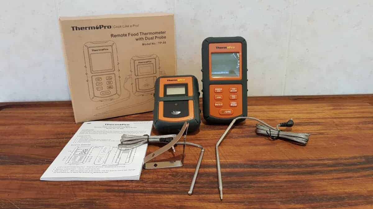 Contents of Thermopro tp08 thermometer laid out on a chopping bo.