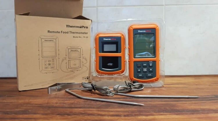 Contents of Thermopro tp20 thermometer box laid out on a chopping board.