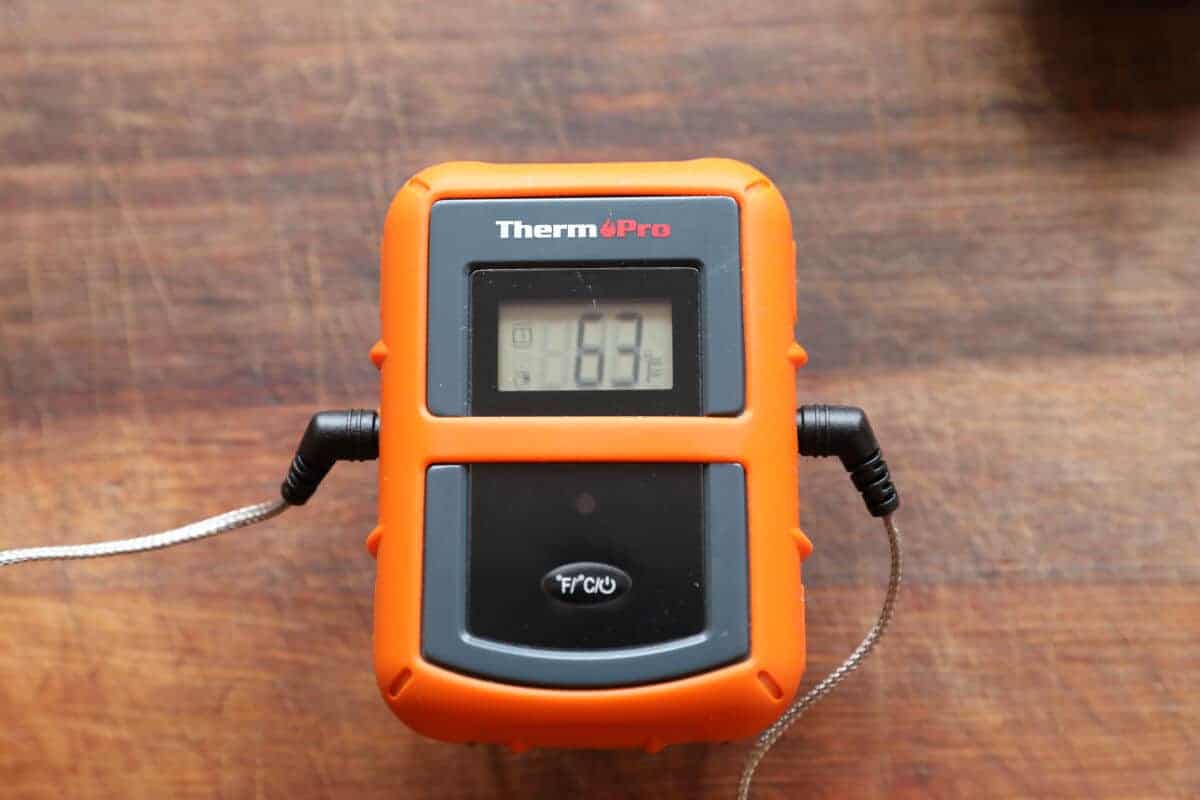 The thermopro tp20 thermometer transmitter on a chopping bo.