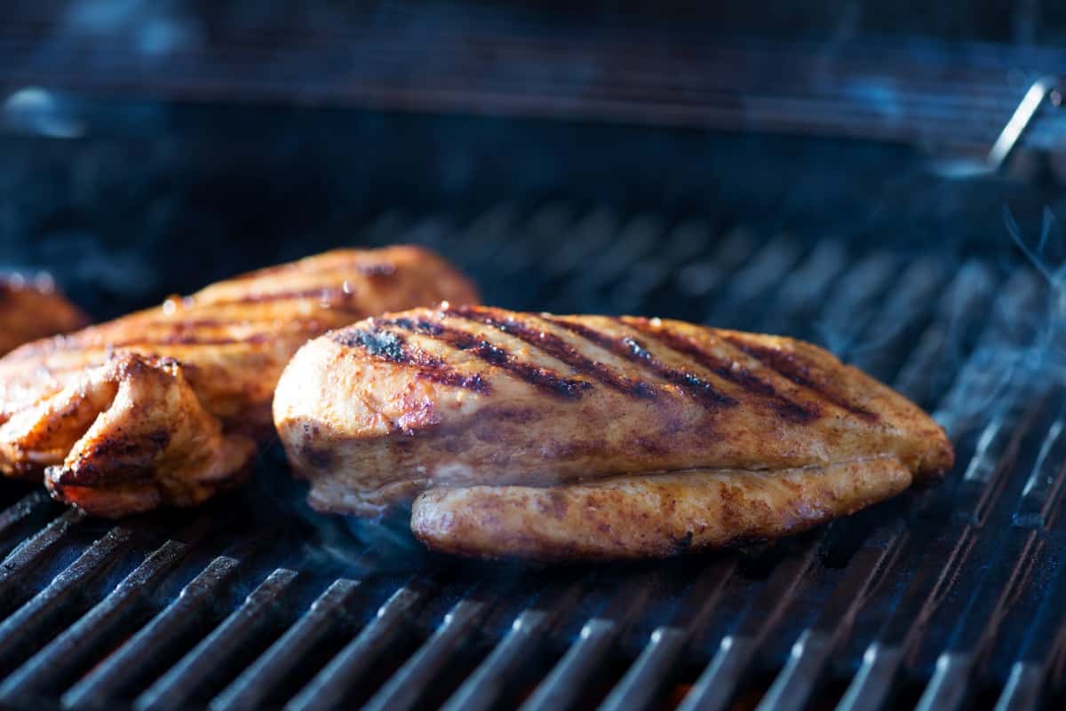 Two chicken breasts on a grill