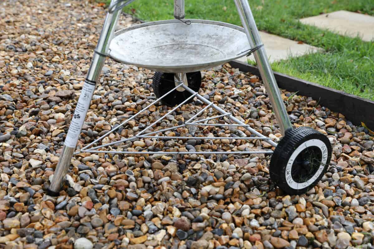 Close up of Weber kettle ash catcher and storage shelf.