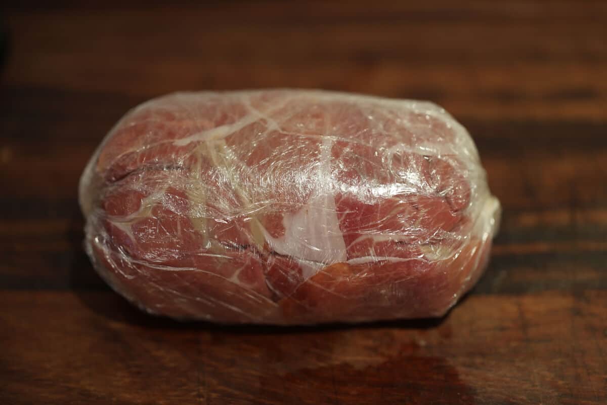 Beef filet, duxelle and ham rolled into a sausage and wrapped in cling film