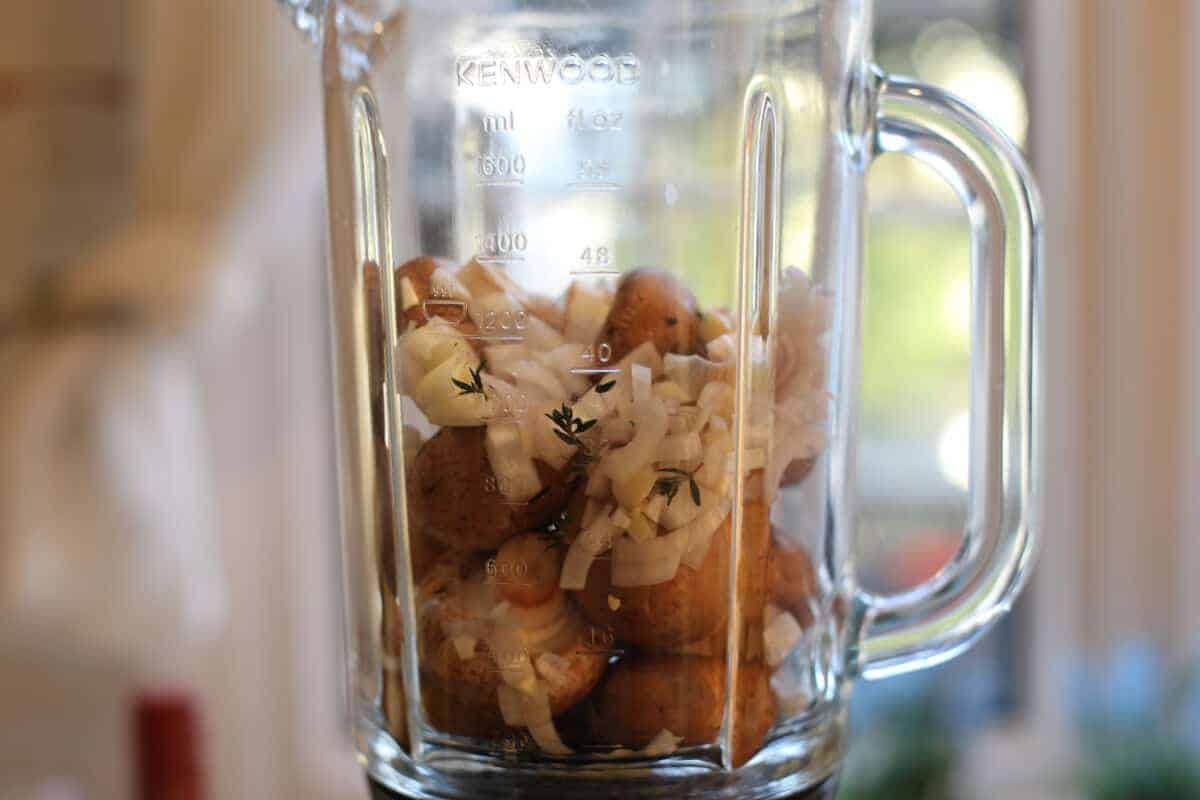 A blender full of mushroom, shallot and thyme to make a duxelle