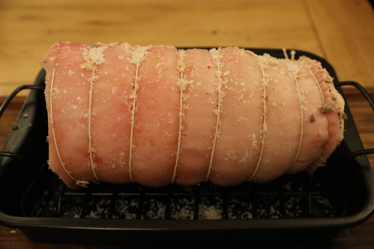 Porchetta prepared, ied and salted in a roasting pan