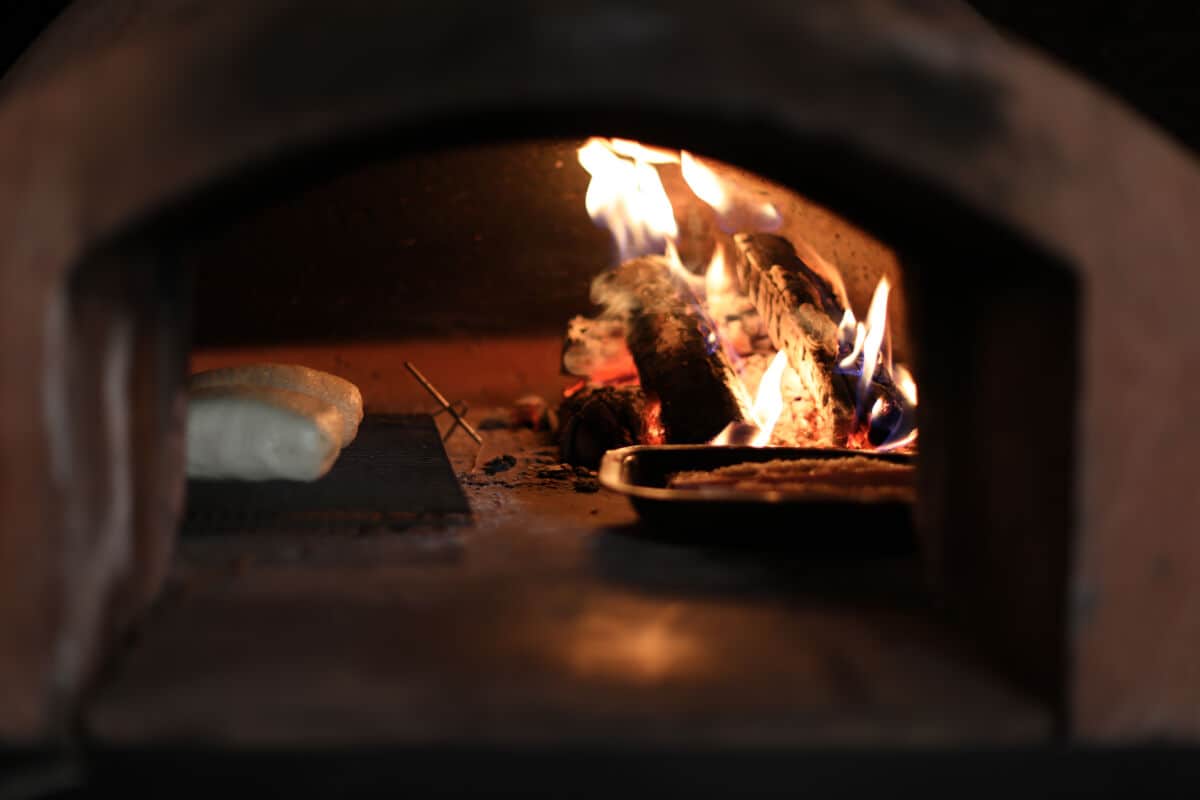 two beef wellington in a WFO with a digital thermome.