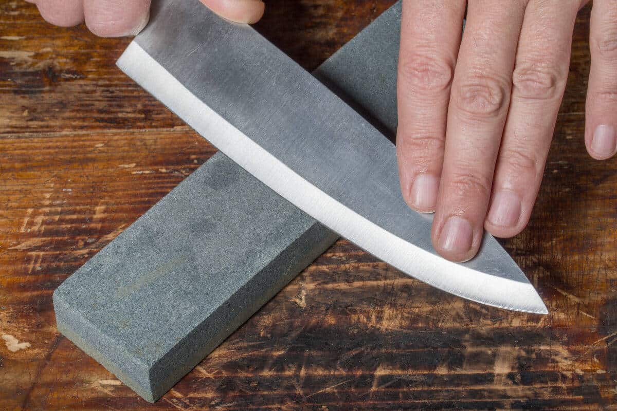 Image of a knife being sharpened on a whetstone