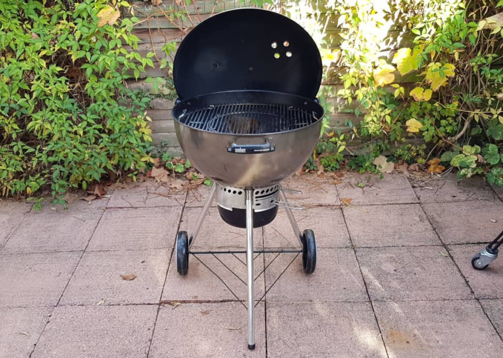 A bronze colored Weber Mastertouch charcoal kettle grill