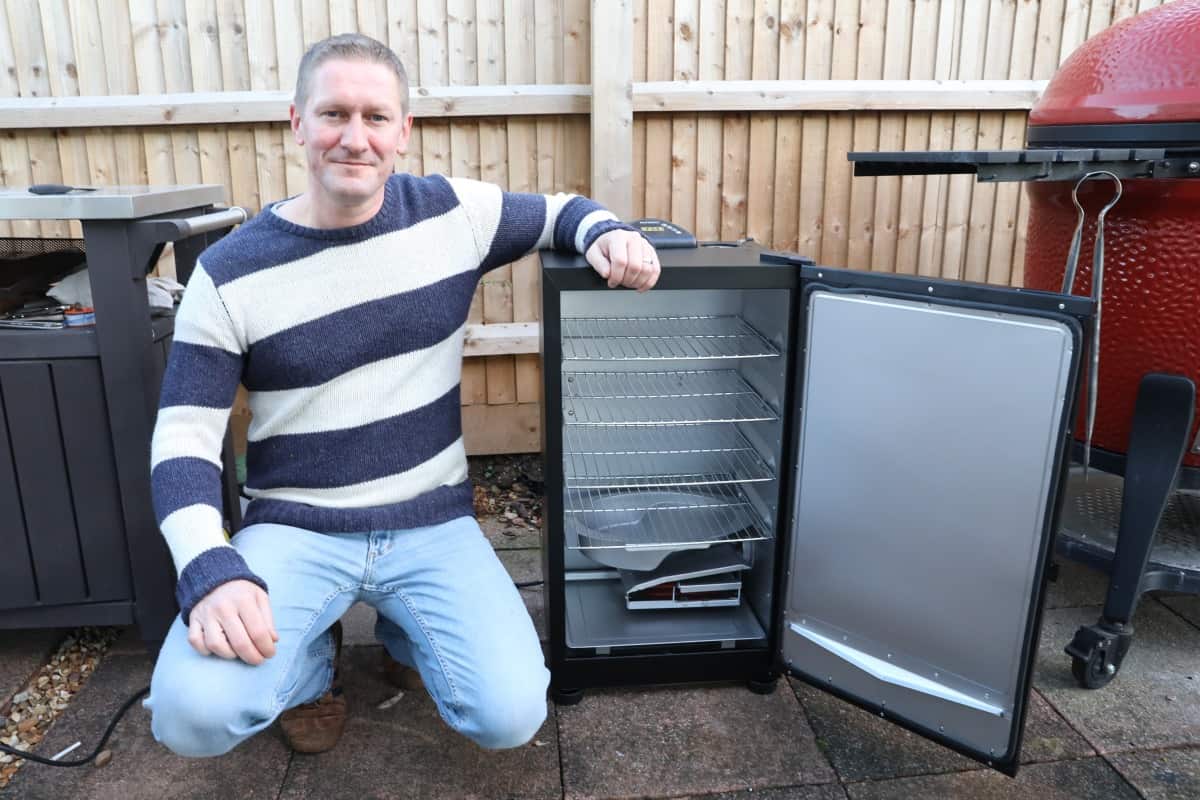 Me beside the Masterbuilt electric smoker with door o.