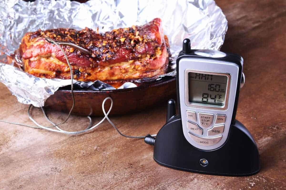 A wireless smoker thermometer on a kitchen worktop showing temp of m.