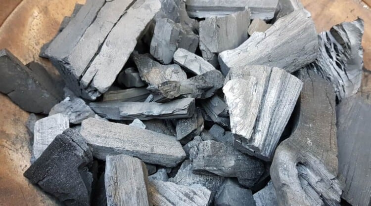 A firebox full of the best lump charcoal, ready for grilling.