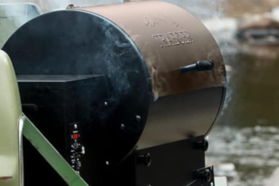 a Traeger pellet grill, smoking away on a tailg.