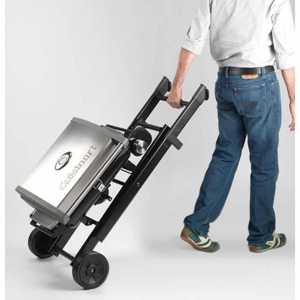 Cuisinart all foods roll away gas grill folded flat and being wheeled away by a man, isolated on white